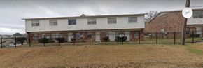 Jackson apartment for rent - the front of a white building with a black fence