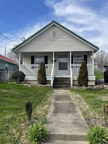 Johnson City house for rent - a small white house with a porch and a sidewalk