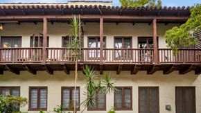 Los Angeles apartment for rent - A building with a balcony and a palm tree in front.