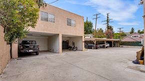Los Angeles apartment for rent - A tan building with a black truck parked in front.