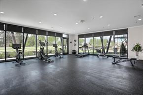 Rochester Hills apartment for rent - A gym with a row of exercise bikes and a bench.