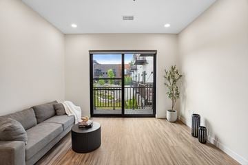 Rochester Hills apartment for rent - A living room with a grey couch and a coffee table.