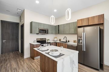 Rochester Hills apartment for rent - A modern kitchen with a white countertop and stainless steel appliances.