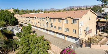 Pacoima apartment for rent - A long building with a sign on it.
