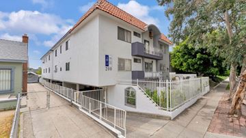 Los Angeles apartment for rent - A white building with a red roof and a blue sign that says "200" on it.