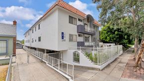 Los Angeles apartment for rent - A white building with a red roof and a blue sign that says "200" on it.