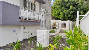 Los Angeles apartment for rent - A white statue of a woman stands in front of a house.
