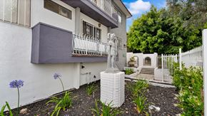 Los Angeles apartment for rent - A white statue of a person stands in a garden.
