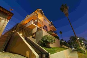 Los Angeles apartment for rent - A building with a palm tree in front of it.
