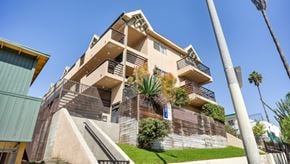 Los Angeles apartment for rent - A modern building with a green lawn in front.