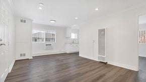 Los Angeles apartment for rent - A spacious room with wooden floors and white walls.