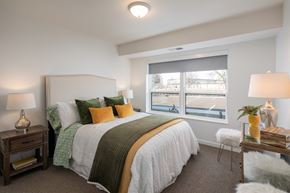 Mounds View apartment for rent - a bedroom with a large bed and a window