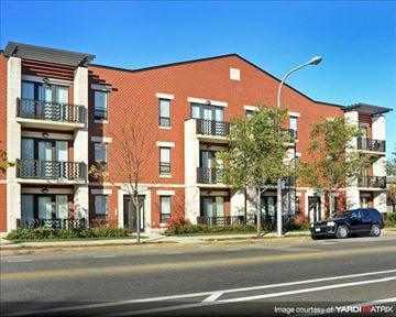 Chicago apartment for rent - a car parked in front of a brick building