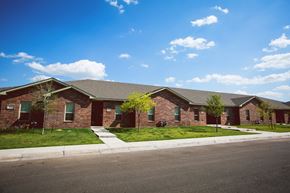 Amarillo apartment for rent - a red brick house with a street in front of it