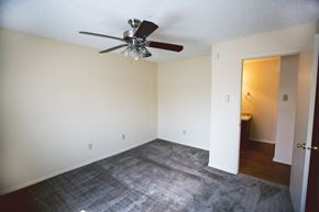 Amarillo apartment for rent - an empty living room with a ceiling fan and carpet