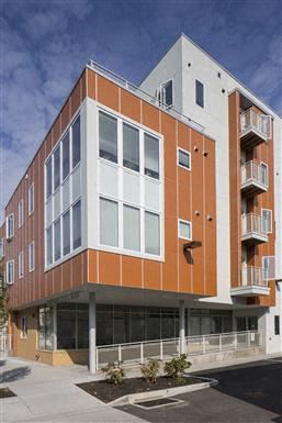 Philadelphia apartment for rent - a large orange and white building on the side of a street