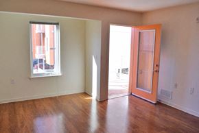 Philadelphia apartment for rent - an empty living room with an orange door and a window