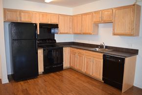 Philadelphia apartment for rent - a kitchen with black appliances and wooden cabinets