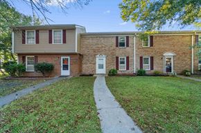 Jacksonville house for rent - A brick house with a red door and a white door.
