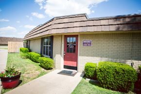 Amarillo apartment for rent - the front of a brick building with a red door