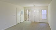 Mountville apartment for rent - an empty living room with a door to a hallway