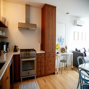 Seattle apartment for rent - a kitchen with a stove and a table and a living room