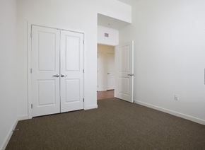 York apartment for rent - an empty bedroom with white doors and carpeting