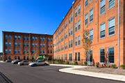 York apartment for rent - a large brick building with cars parked in front of it