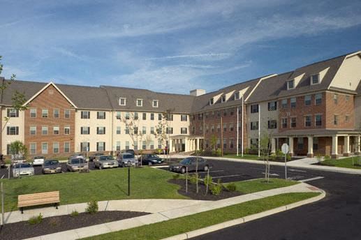Camden apartment for rent - an apartment building with cars parked in a parking lot