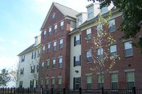 Camden apartment for rent - a large brick building with a fence in front of it