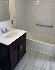 Jersey City apartment for rent - A white sink is on a counter in a bathroom.