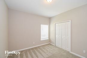 Yulee house for rent - a bedroom with a closet and a door and a window