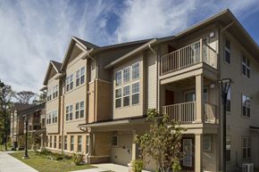 Cedar Knolls apartment for rent - a row of apartment buildings with balconies and a sidewalk