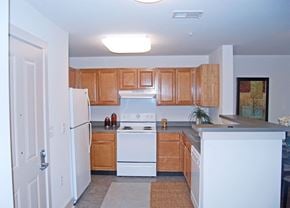 Jersey City apartment for rent - a kitchen with white appliances and wooden cabinets