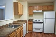 Pennington apartment for rent - an empty kitchen with white appliances and wooden cabinets