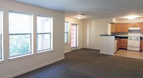 Manalapan apartment for rent - an empty living room with a kitchen and a window