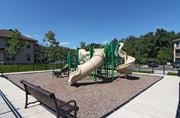 Manalapan apartment for rent - a playground with slides and benches in a park