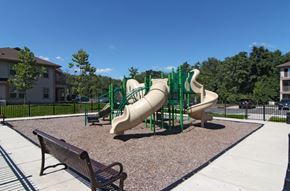 Manalapan apartment for rent - a playground with slides and benches in a park