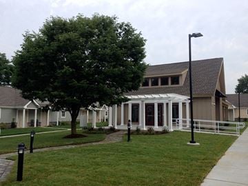 Wilmington apartment for rent - A tree in front of a building with a white fence in front of it.