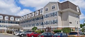 Avenel apartment for rent - a large apartment building with cars parked in front of it