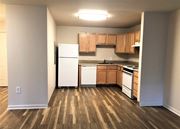 Avenel apartment for rent - a kitchen with wood flooring and white appliances and cabinets