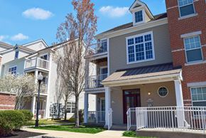 Medford apartment for rent - an apartment building with a red brick exterior and a white fence