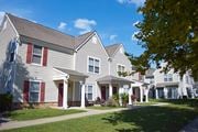Farmingdale apartment for rent - a row of houses with red doors and white siding