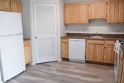 Farmingdale apartment for rent - a kitchen with wooden cabinets and a white refrigerator