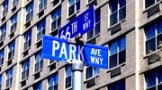 West New York apartment for rent - a couple of blue street signs in front of a building
