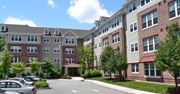 Perth Amboy apartment for rent - an exterior view of an apartment building with a parking lot