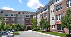 Perth Amboy apartment for rent - an exterior view of an apartment building with a parking lot