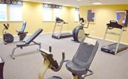 Perth Amboy apartment for rent - a gym with various exercise equipment in a treatment room