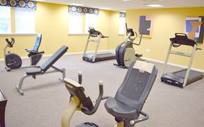 Perth Amboy apartment for rent - a gym with various exercise equipment in a treatment room
