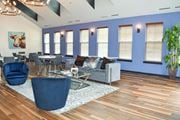 Pilesgrove apartment for rent - a living room with blue walls and wood floors and blue chairs